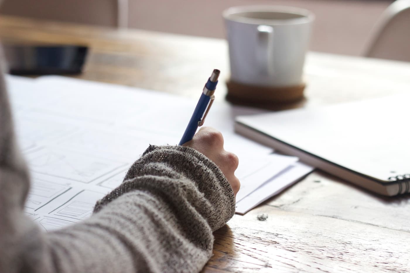Student writing notes for a letter of recommendation and university application